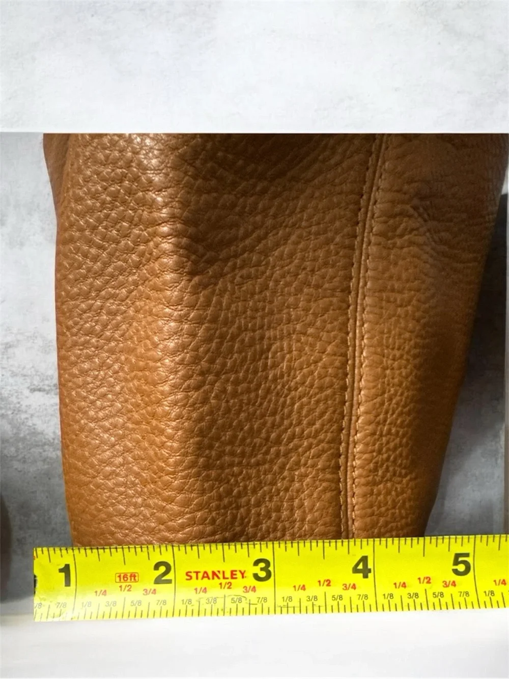 Michael Kors Cognac Pebbled Leather Shoulder Bag with Gold logo on the side.